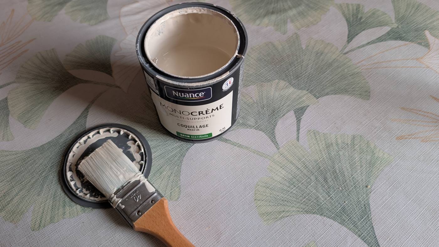 Pot de peinture claire et pinceau pour repeindre le meuble